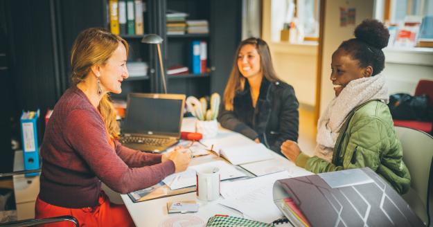 De studentenbegeleider in gesprek met studenten